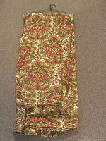 Folded chintz curtain panels on hanger