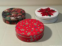 Three round Christmas tins grouped