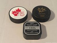 Front view of all three pucks showing logos and shapes
