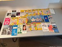 Full set of 34 folded maps spread on table