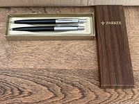 Pen and pencil inside Parker case with lid alongside