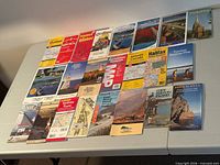 All 23 folding maps laid out on table