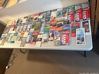 All 66 folded maps laid out on folding table