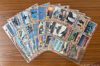 Fronts of trading cards fanned in binder sleeves