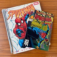 Front covers of Spider-Man: The Ultimate Guide hardcover and Spider-Man 2099 #6 comic