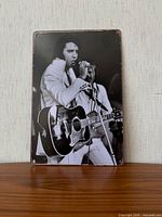 Front of metal sign showing Elvis Presley image and overall condition