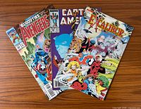 Fanned arrangement of the three comic books showing front covers