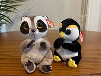 Front view of both plush toys showing tags and details