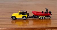Left side view of Jeep towing boat on trailer