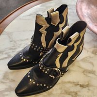 Boots side view showing gold overlays and studded harness