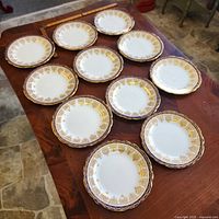 Overview of 11 Aynsley plates on table
