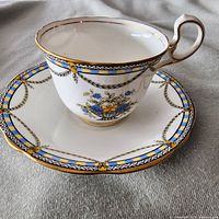 Teacup on saucer showing pattern and trim