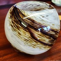 Overall view of spherical vase showing swirled pattern