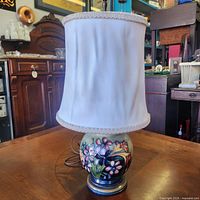 Full view of lamp showing ceramic base and fabric shade