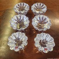 Six Orrefors flower-shaped crystal candle holders on tabletop