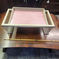 Top view of wooden raised serving tray showing wicker insert and spindle legs