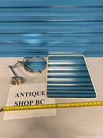 Both mirrors laid out with tape measure for scale