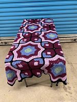 Blanket spread over table, full view of pattern and colors