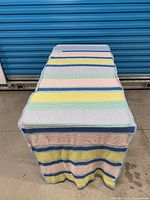 Full view of folded blanket showing overall stripe pattern and colours