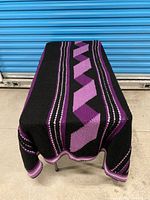 Blanket draped over table showing full top view of geometric pattern