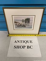 Full view of framed print with tape measure for scale