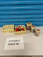 Group shot of all five tins showing relative sizes and designs