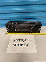 Front view of entire Sanyo M7030 boombox with measuring tape