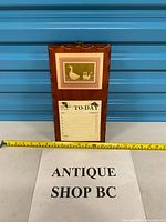 Front view of wall organizer with goose print and note pad