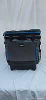 Front view of Igloo gray/black soft-sided rolling cooler with blue trim