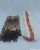 Both scarves folded on backdrop