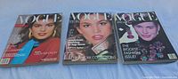 Front covers of all three Vogue magazines showing titles, cover models and wear