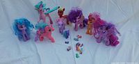 Eight large ponies with brushable hair and ten mini figures arranged on white cloth