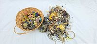 Basket and pile of mixed jewelry pieces