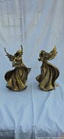 Front view of both gold-tone angel candle holders