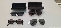 All four sunglasses and two cases overview