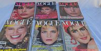 Front covers of six Vogue issues laid out