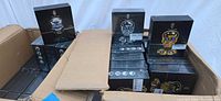Open carton showing multiple boxed YverBlade skull shaver sets in gold and silver designs
