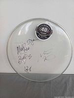 Full view of signed clear drumhead with decal