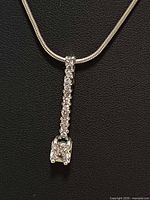 Necklace close-up showing pendant detail and chain texture