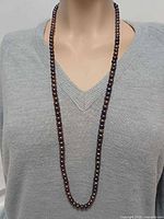 Necklace worn on mannequin showing full 34-inch drape