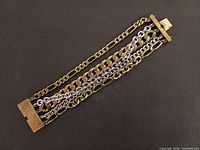Full view of multi-strand brass and silver bracelet, front side