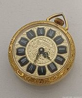 Front view showing dial, Roman numerals and brand