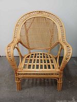 Front view of bamboo rattan lounge chair showing woven cane back and open-slat seat