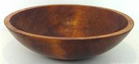 Side view of wooden bowl showing overall shape and finish