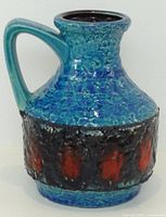 Full view of Bay West Germany blue lava glaze handled vase