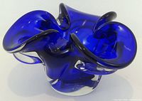 angled view showing cobalt blue free-form bowl with clear base