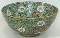 Exterior view of porcelain bowl showing turquoise floral enamel pattern and gilded foot