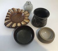 Group of five pottery pieces showing shapes and glazes