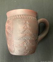 Front view showing Tree of Peace relief and geometric band