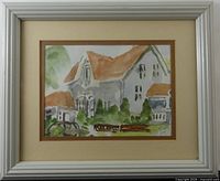Front view of framed watercolour cottage scene